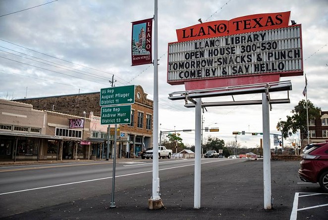 Cars pass by the the Llano County Courthouse. - Texas Tribune / Sergio Flores