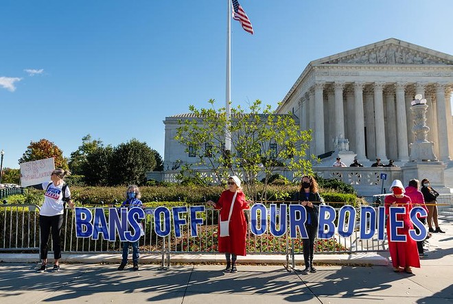 Protesters hold signs reading, “Bans off our bodies,” outside the Supreme Court in Washington, D.C. - Texas Tribune / Eric Lee