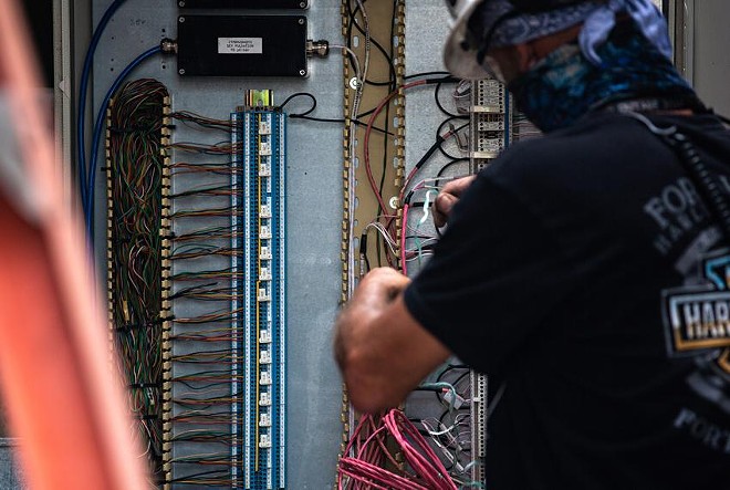 A power plant employee adjusts the wiring of a power unit in North Texas. The Texas energy sector has been increasingly probed for weaknesses by computer hackers from Russia, according to a cybersecurity expert whose company has monitored cyber threats in Texas. - Texas Tribune / Shelby Tauber