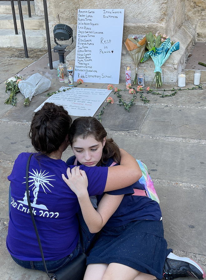 Yaiza Inman-Ortiz, 13, in consoled by her mother, Loreily Ortiz, following Tuesday evening's prayer vigil. - Michael Karlis