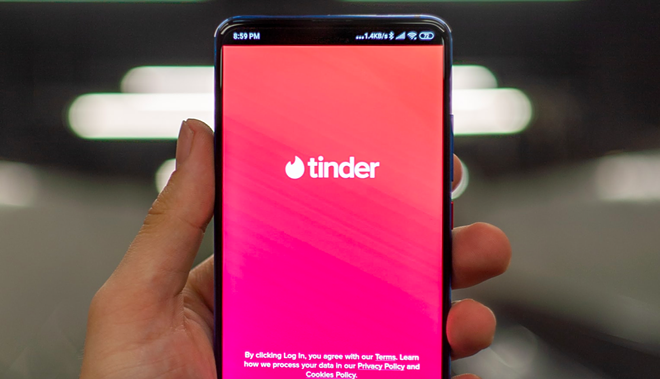 An iPhone shows off the Tinder app. - UnSplash / Mika Baumeister