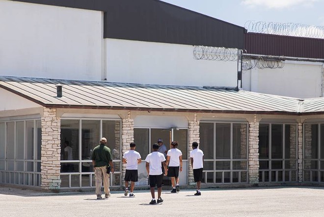 With enough staff on campus on July 20, detainees walk towards the Giddings’ gym for recreation. - Texas Tribune / Jolie McCullough