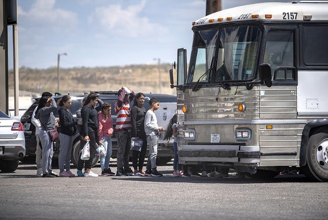 People who were apprehended by state troopers after crossing the border were brought to the International Bridge in Eagle Pass, where they were handed over to Border Patrol custody on Thursday, May 28, 2022. - Texas Tribune / Sergio Flores