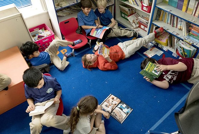 At the Advanced Learning Academy at Euclid in San Antonio, second grade students read while their teacher works individually with students. - Texas Tribune / Laura Skelding