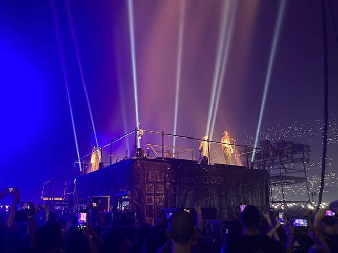 The members of Rammstein stand on a platform in the middle of the Alamodome. - Garrett T. Capps