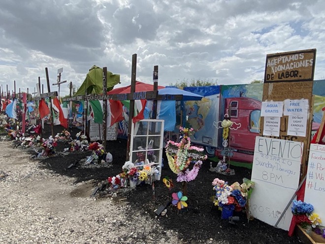 A makeshift memorial has grown up around the site where more than 50 migrants died in the back of a tractor-trailer abandoned in San Antonio. - Sanford Nowlin