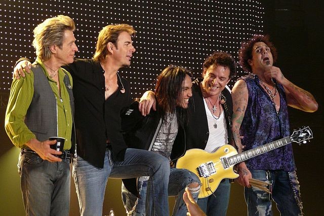 Members of Journey take a bow during a concert appearance. - Wikimedia Commons / Matt Becker