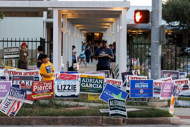 Signs and electioneers greet voters at the Metropolitan Multi-Service Center in Houston, Tuesday Nov. 8, 2022. - Texas Tribune / Michael Stravato