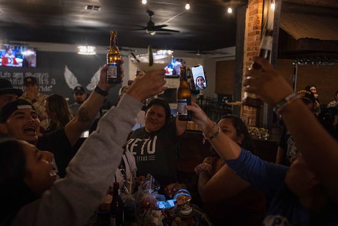 Families of the Robb Elementary shooting victims cheers each other at the election watch party after they each tried to cheer up Faith Mata, who called her parents from her dorm at Texas State in San Marcos, upset after seeing the news that Greg Abbott won reelection. - Texas Tribune / Evan L'Roy