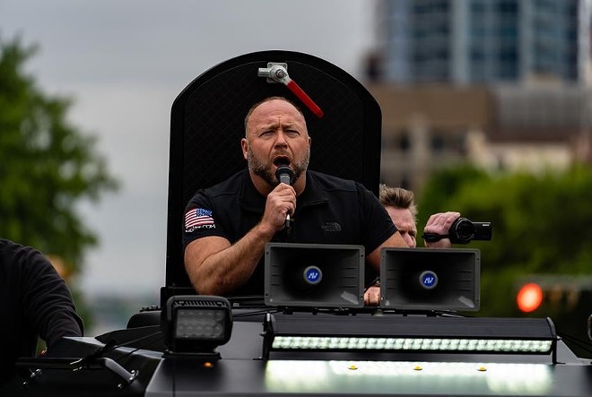 InfoWars founder Alex Jones speaks to a crowd over a loudspeaker from his InfoWars vehicle as hundreds attended a “Re-Open America” protest near the Texas Capitol in Austin in 2020. Jones filed for bankruptcy on Friday, Dec. 2, 2022. - Texas Tribune / Jordan Vonderhaar