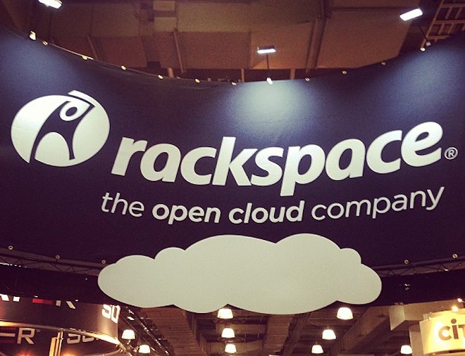 A banner hangs above a Rackspace display at a trade show. - Instagram / rackspace_technology
