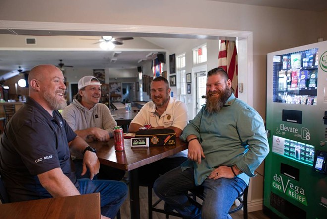 From left: Chris Bentler, Scott Vanlandingham, Dave Walden and John Jowers chat at a table inside the VFW post in Leander on Nov. 1. - Texas Tribune / Azul Sordo