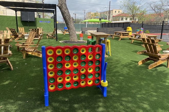 New patio bar Home Room features picnic tables and games such as this giant Connect 4. - Sanford Nowlin