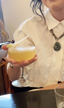 A preview guest sips Tokyo Cowboy's Senpai Sour cocktail. - Nina Rangel