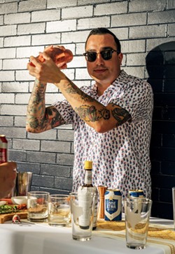Squeezebox and Amor Eterno owner Aaron Peña shakes up a Texas Heat cocktail. - Courtesy Photo / Lone Star Brewing
