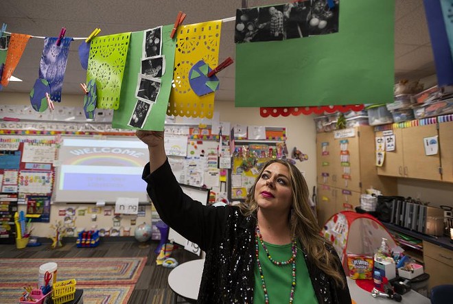 Chana Jones adjusts a decoration in her class room in Snyder Primary School. Jones is a kindergarten teacher at Snyder ISD, a district with less than 3,000 students about an hour and a half away from Midland. - Texas Tribune / Justin Rex