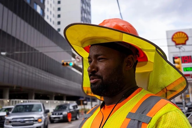 Marque Clark, 41, a traffic control employee, works through the heat in Austin. - Texas Tribune / Joe Timmerman