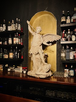 A large statue of Archangel Michael overlooks La Ruina's upstairs bar. - Nina Rangel