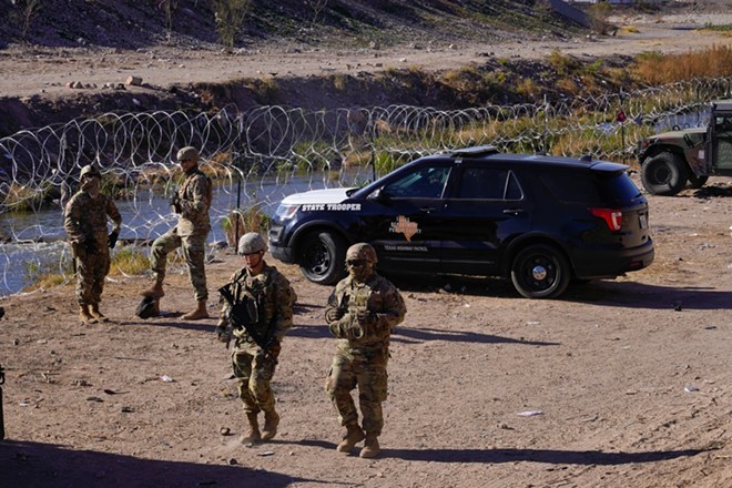 A Texas DPS vehicle is parked along the Rio Grande River. - Shutterstock / Ruben2533