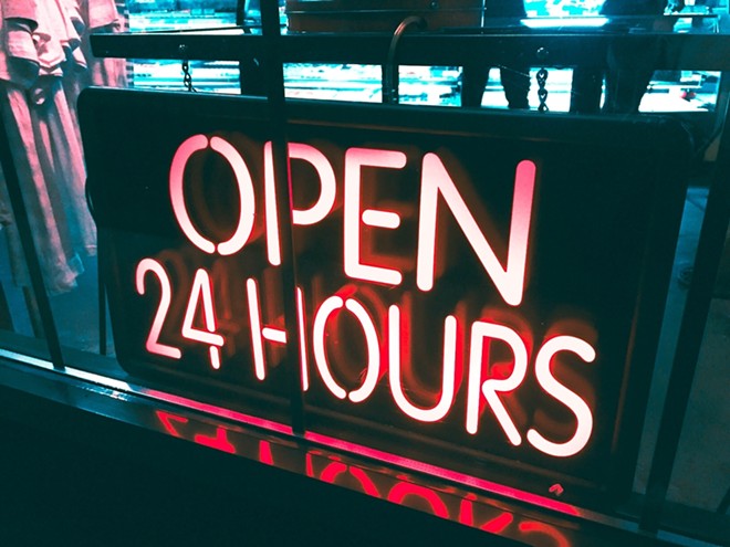 A neon "open 24 hours" sign. - Unsplash / Alina Grubnyak