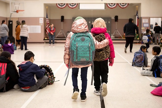 One student embraces another in Cactus Elementary School in Cactus on Jan. 28, 2020. - Texas Tribune / Miguel Gutierrez