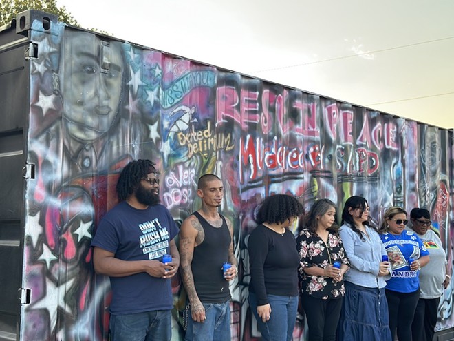 The family members and friends of Baltasar Rodriguez Jr., Andre "AJ" Hernandez and Marquis Jones stand in front of the mural unveiled in Friday, Sept. 1. - Michael Karlis