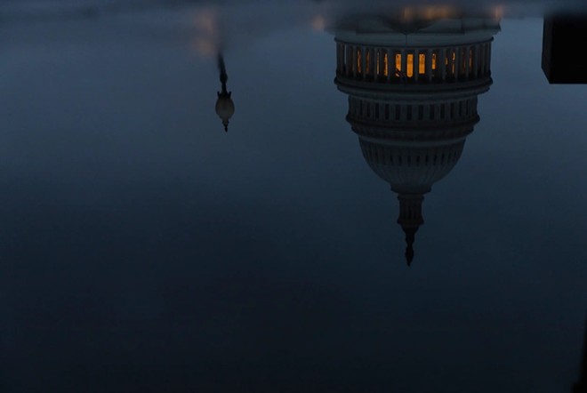 The U.S. Capitol, seen in a reflection, on a cloudy evening Jan. 22, 2023 in Washington D.C - Texas Tribune / Eddie Gaspar