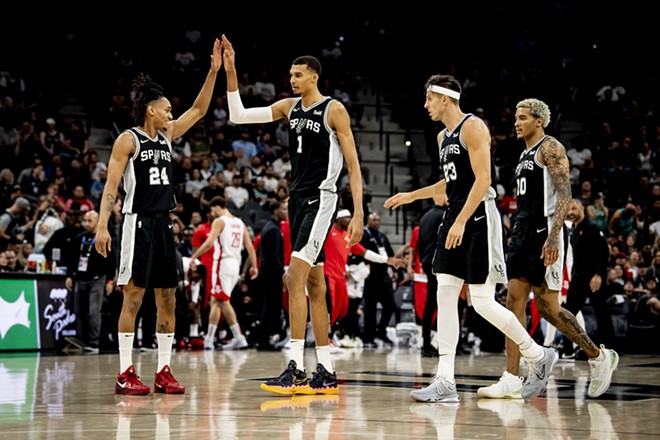 Spurs forward Victor Wembanyama high-fives teammate Devin Vassell during a matchup against the Houston Rockets earlier this season. - Reginald Thomas II / San Antonio Spurs