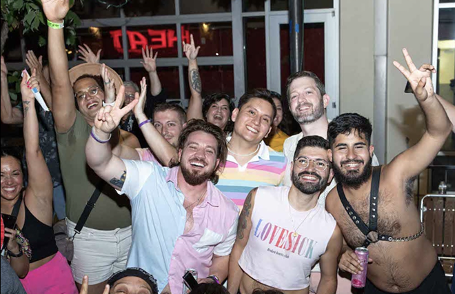 Revelers take in a Pride parade from the Main Strip. - Julian P. Ledezma