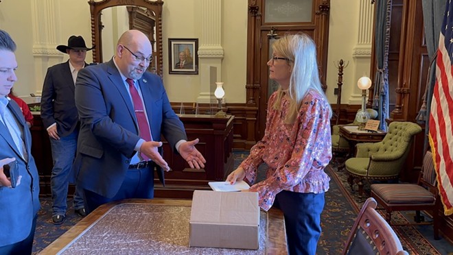 Texas Nationalist Movement President Daniel Miller delivers a petition to Gov. Greg Abbott's office calling for the state to secede from the union. - Michael Karlis