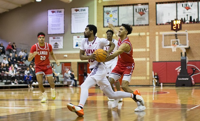 A UIW men's hoops player speeds past an opponent. - Courtesy Photo / UIW Athletics (Vashaun Newman)