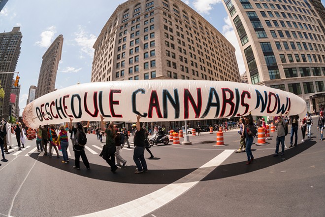 Marchers at a street protest demand cannabis reform. - Shutterstock / rblfmr