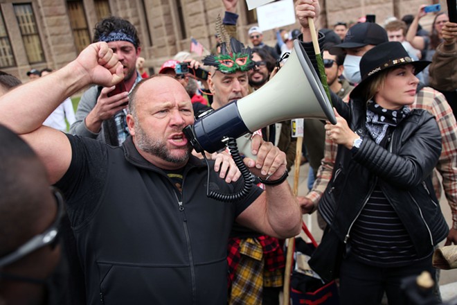 Right-wing conspiracy theorist Alex Jones speaks to a crowd protesting COVID-19 lockdown mandates during a protest in Austin in 2020. - Shutterstock / Vic Hinterlang
