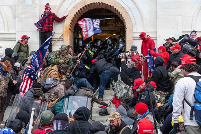 Police battle with supporters of Donald Trump as they try to enter the front doors of the U.S. Capitol on January 6. - Shutterstock / lev radin