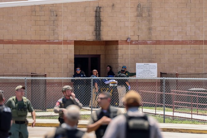 Authorities gather outside of Robb Elementary School in Uvalde after a gunman entered and killed 19 students and two teachers on May 24, 2022. - Texas Tribune: Courtesy Photo / Pete Luna of the Uvalde Leader-News