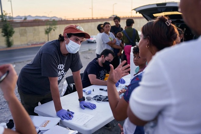 Dr. Brian Elmore of Clinica Hope, which gives medical care, food and water to migrants who are waiting to cross the border along the U.S.-Mexico border, speaks to migrants requesting medical attention in Ciudad Juarez, Mexico on June 1, 2024. Elmore is an emergency medical physician at University Medical Center Hospital in El Paso and said he often sees migrants who have been injured on the border. - Texas Tribune / Paul Ratje