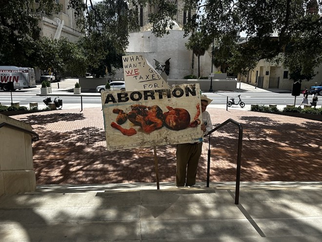 San Antonio conservative gadfly Jack Finger holds a sign with a photo of a mutilated fetus. - Michael Karlis