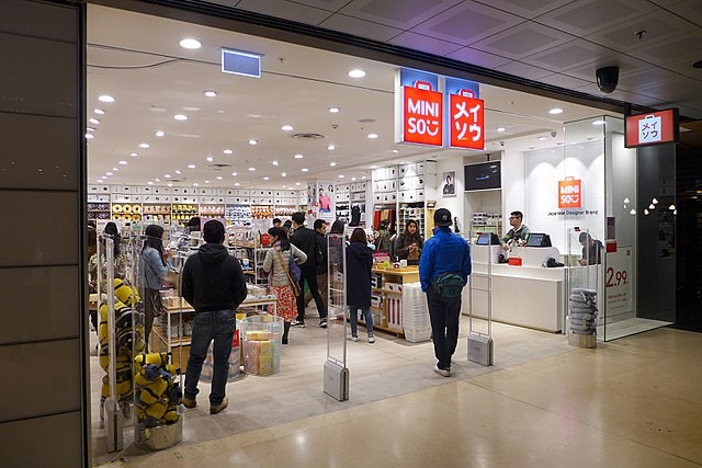 Shoppers peruse "cute stuff they don't need" at a Miniso location in Sydney, Australia. - Wikimedia Commons / Wpcpey