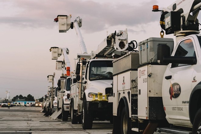 Electric trucks line up to provide support with major power outages after Hurricane Beryl in Houston on July 10, 2024. - Texas Tribune / Joseph Bui