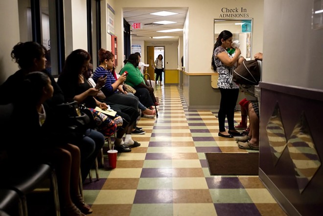 Patients wait to be seen at the People's Community Clinic in Austin, a federally qualified health center, which provides health services to low-income families and individuals. - Texas Tribune / Callie Richmond