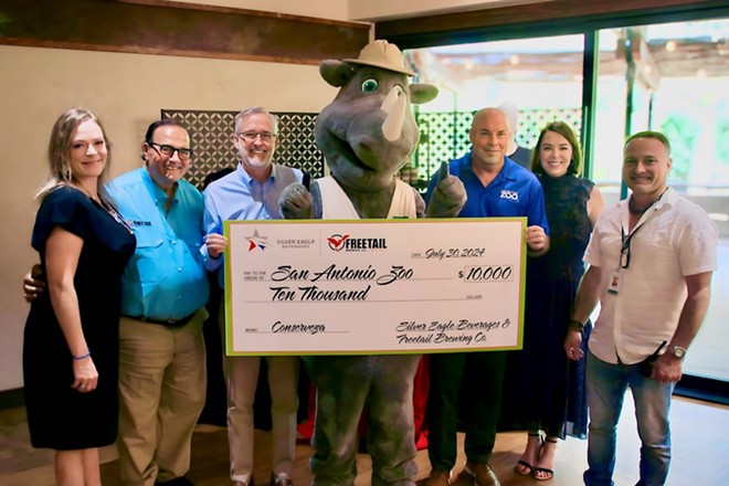 Executives from Freetail Brewing and Silver Eagle Beverages present a $10,000 check to the San Antonio Zoo on Tuesday. - Courtesy of San Antonio Zoo