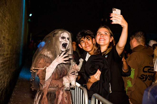 Visitors to San Antonio's 13th Floor Haunted House selfie with a ghoulish presence. - Courtesy Photo / 13th Floor Haunted House