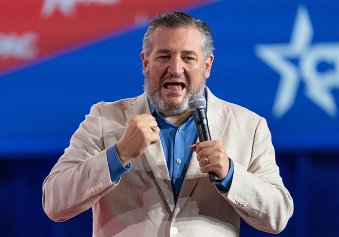 U.S. Sen. Ted Cruz yells into a microphone during the CPAC Texas 2022 conference. - Shutterstock / lev radin