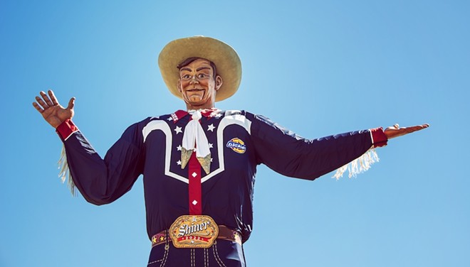 Despite his cowboy duds, the Texas State Fair's towering mascot, Big Tex, doesn't pack a shooting iron on his hip. - Shutterstock / Leena Robinson