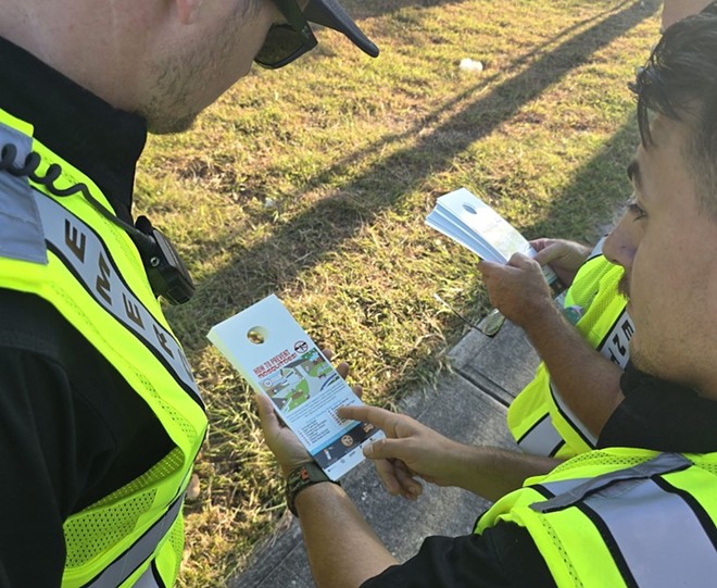 Workers with the Bexar County Office of Emergency Management prepare to distribute door hangers with information on avoiding mosquito-borne diseases. - Courtesy Photo / Bexar County