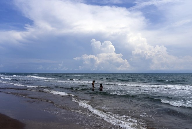 Swimmers at the Boca Chica Beach on Aug. 31. The popular beach near Brownsville is adjacent to a massive SpaceX facility. - Texas Tribune / Ben Lowry