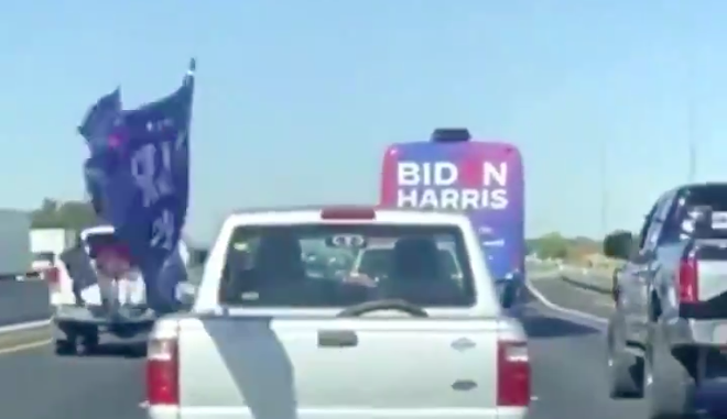 The trucks of Trump supporters swarm a Biden-Harris campaign bus during an incident on I-35 four years ago. - Twitter video capture / @truthserum4all