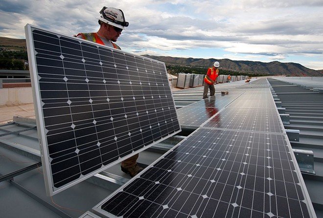 Workers conduct a solar panel installation project. - U.S. Department of Energy