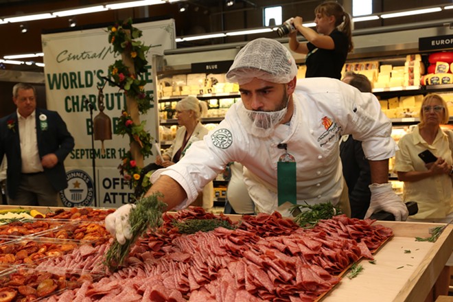 Culinary Development Executive Chef Denis Dello Stritto puts the finishing touches on the record-breaking charcuterie board at Central Market. - Courtesy of Central Market