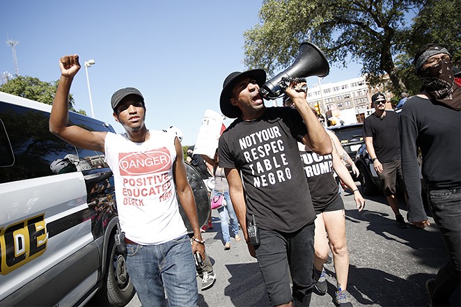 Jonathan-David Jones and Mike Lowe lead the counter-protest to a "Save the Monument" rally on August 12. - TOMAS GONZALEZ